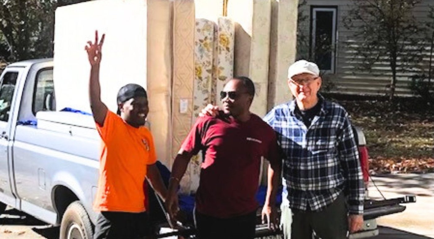 Volunteers delivering mattresses to a refugee family