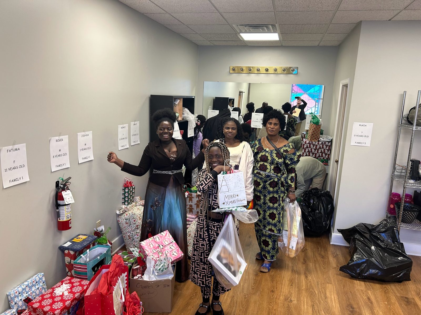 Refugee families gathered at the Hub with gifts for the holidays